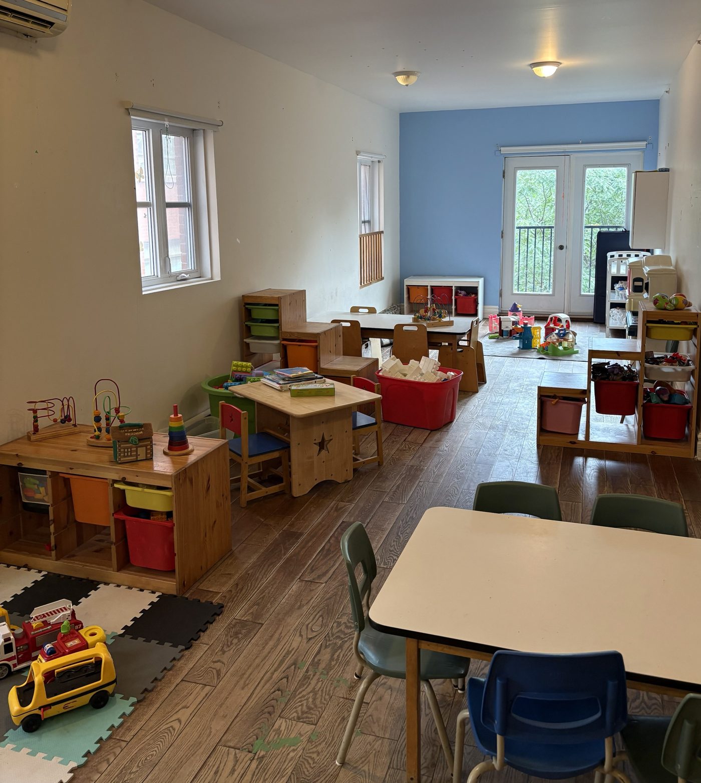 Salle de jeu avec tables et jouets en bois
